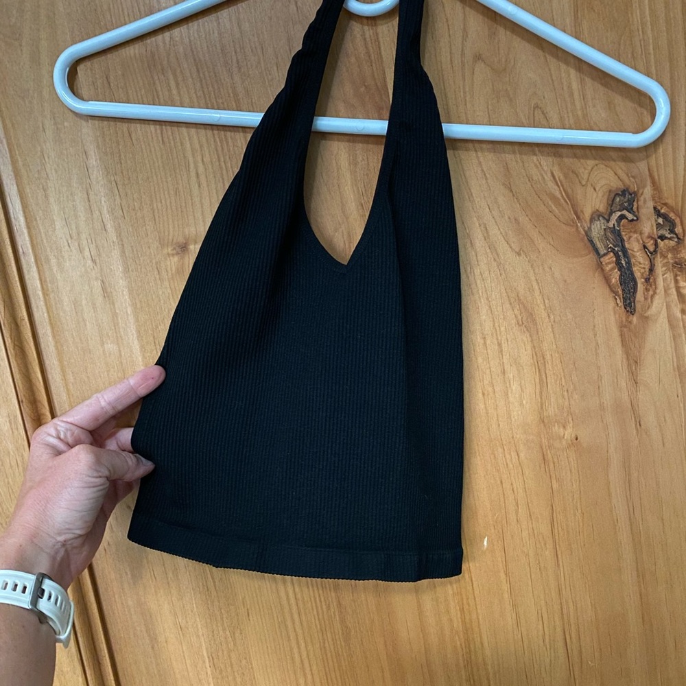 Out from under black halter crop
